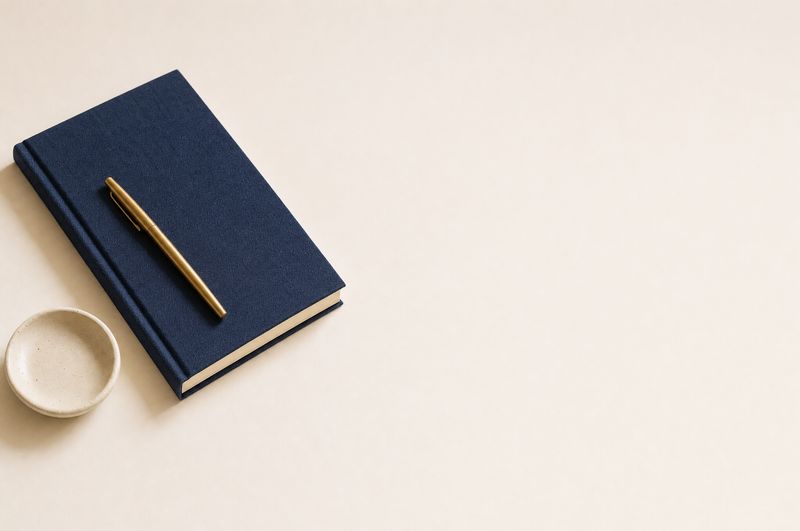 Navy linen notebook with a brass pen